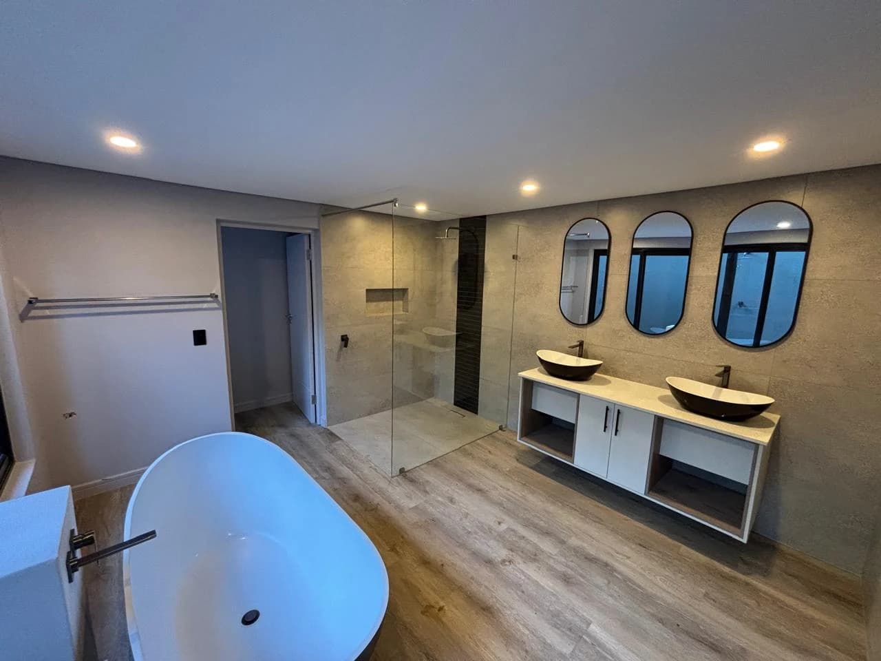 Black Rhino — bathroom with twin basins and a freestanding bath